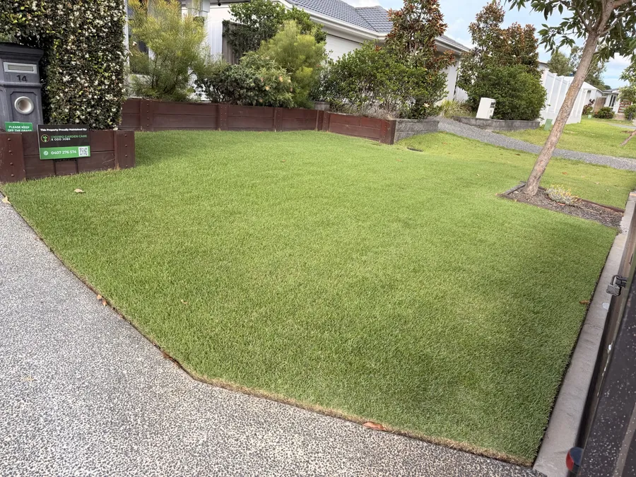 Immaculate front lawn with the Enviro Garden Care yard sign — regular lawn mowing Northern Gold Coast